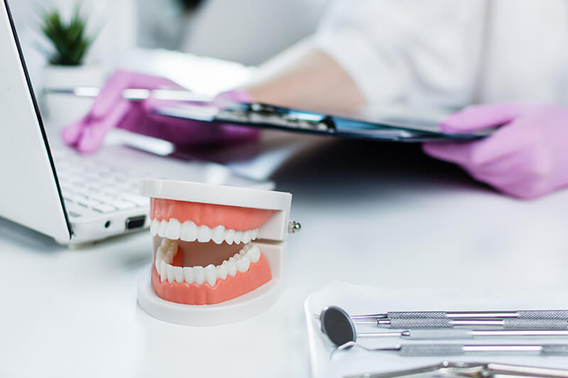 bigstock-Dentist-Holding-Medical-Exam-C-373804318_2