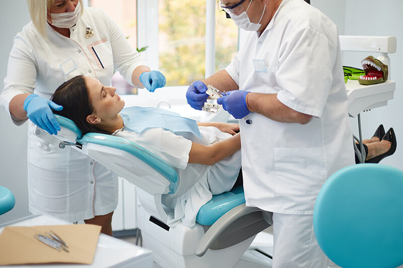 bigstock-Doctor-Dentist-Treats-Teeth-Of-344229001_2
